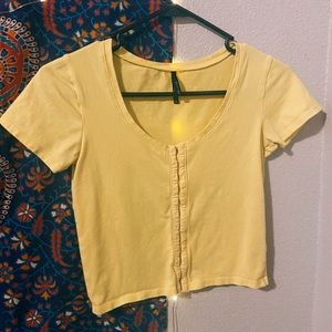 zumiez pastel yellow crop top with clips in front